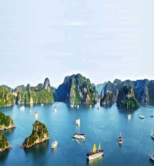 Boats among limestone karst islands in bay